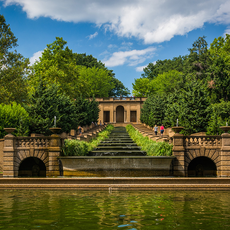 View of water and stairs with a historic building 